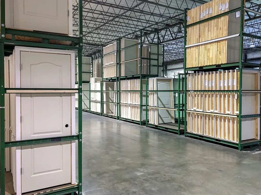 Warehouse racks stocked with prehung interior doors and packaged door units