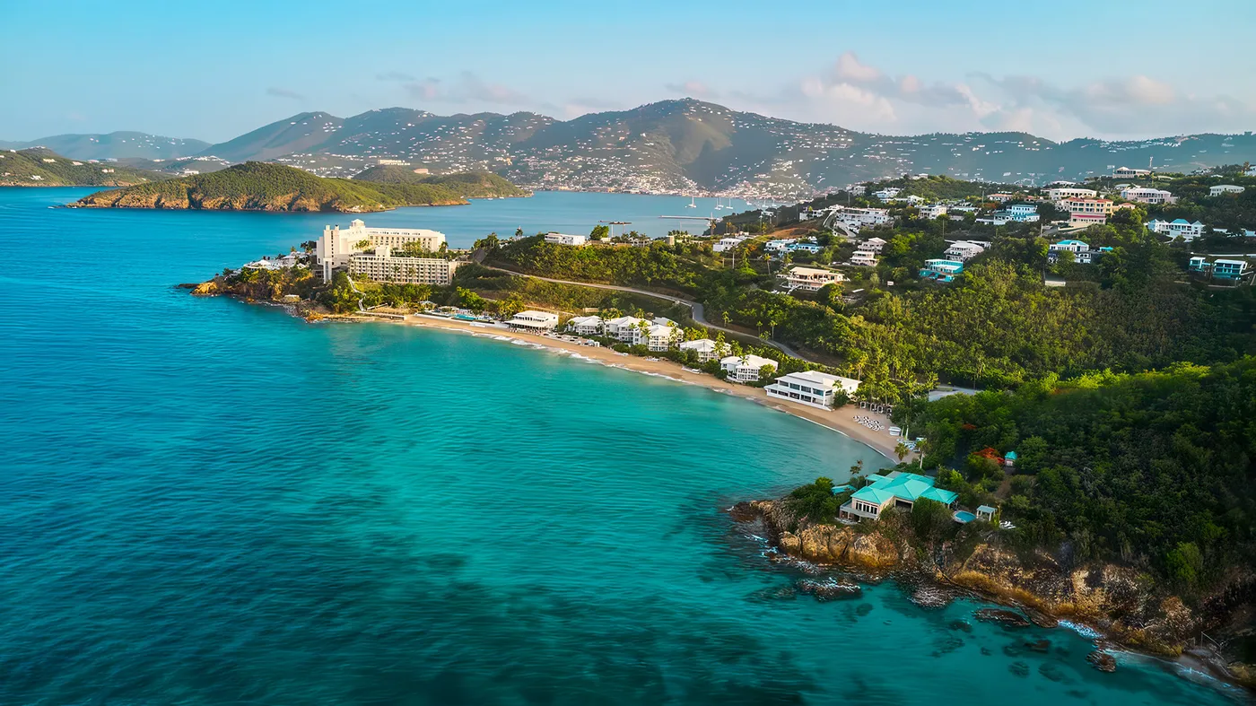 Aerial view of a tropical beach resort on a turquoise bay