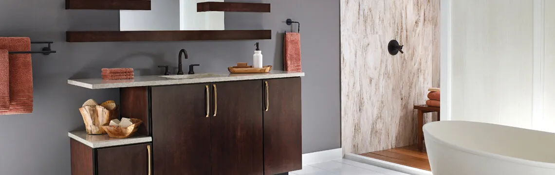 Bathroom with dark wood vanity, stone-look shower wall and freestanding tub