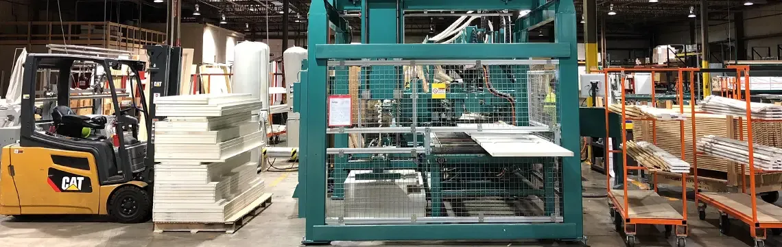 Door machining equipment in a millwork shop beside a forklift and stacked door parts