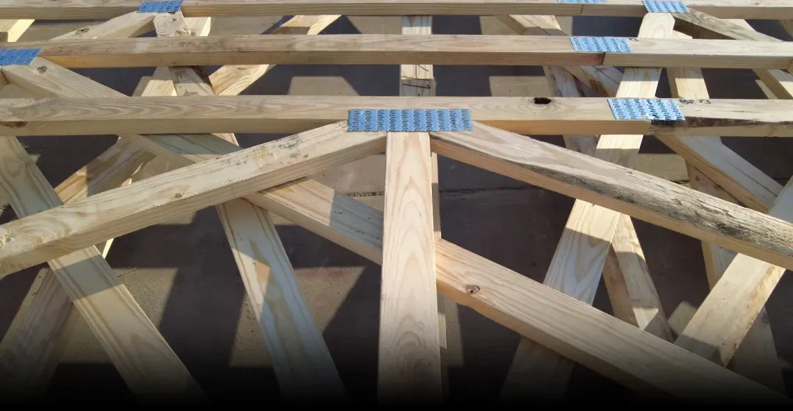 Close view of wood truss members joined with metal connector plates