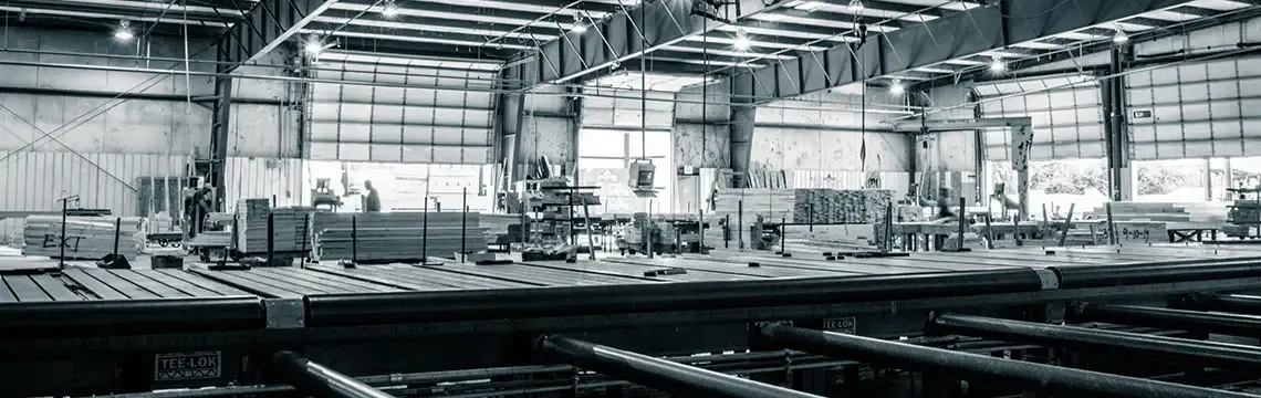 Black and white panorama of a truss plant with long roller conveyor tables